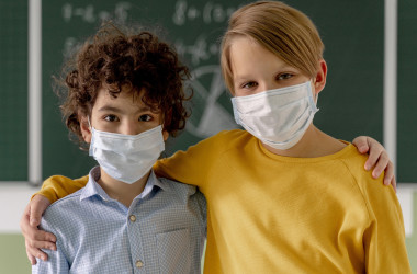 front-view-children-with-medical-masks-posing-classroom-front-blackboard-002 i